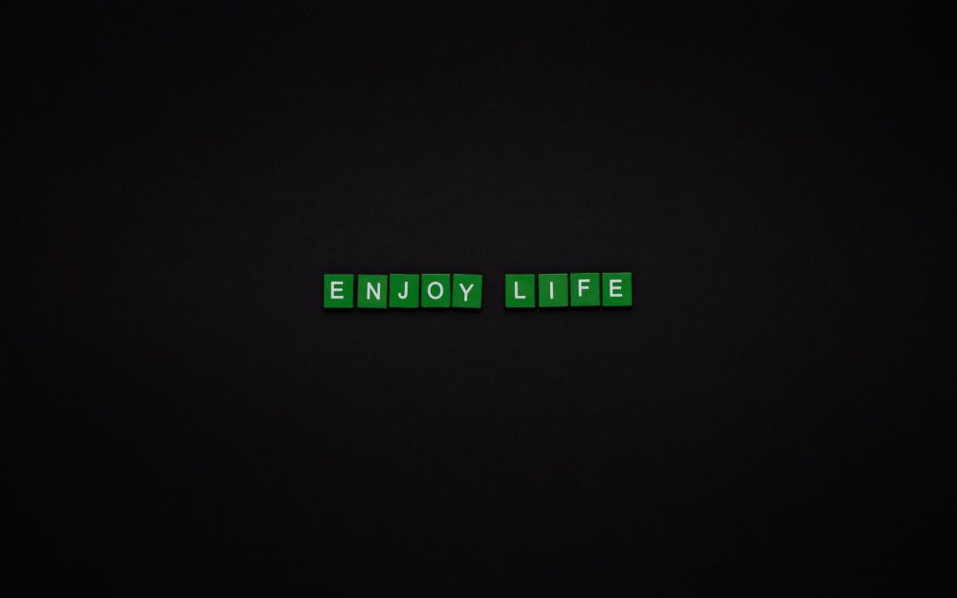 enjoy life text on green tiles with black background